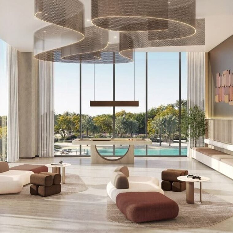 Residents' club lounge at Ellington Villas Dubai — double-height glazing onto the pool, sculptural pendant lighting and low seating