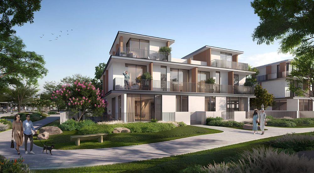 Townhouses and villas at Ellington Villas Dubai — timber-framed balconies above landscaped gardens, with residents walking on shaded pathways
